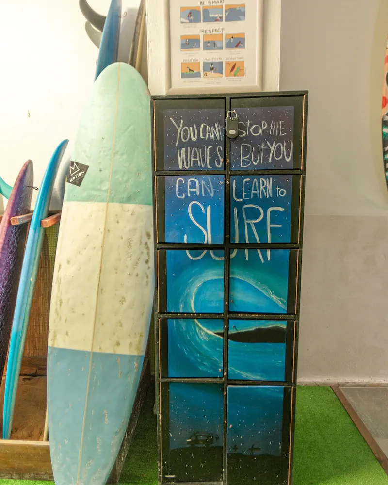 Lockers painted with a wave inside the school, boards leaning beside them