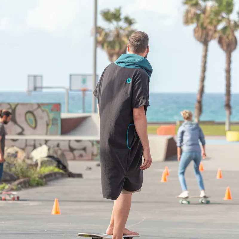 Surf skate practice on the promenade, cones set out and the sea behind