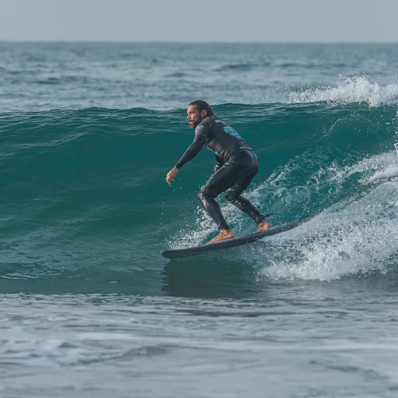 A surfer riding a clean green wave