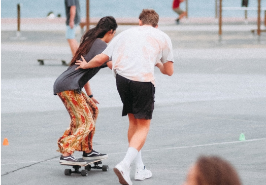Two people practicing surfskate.
